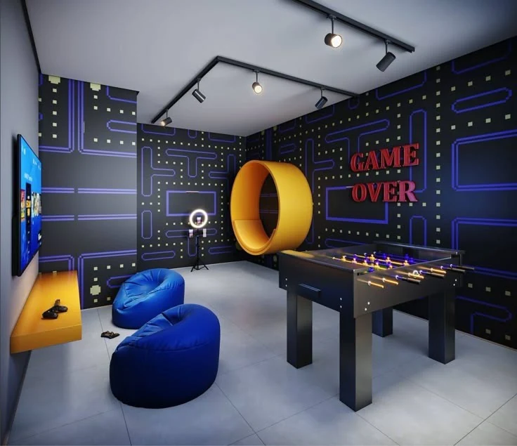 A neon arcade-style club room with a foosball table and bean bags, built for Vayu game nights
